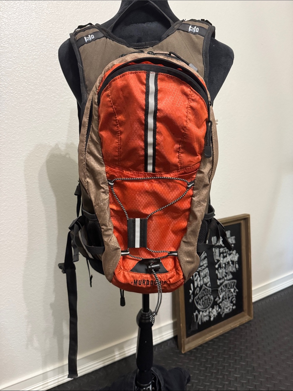 Compact Orange and Brown Hydration Backpack with Front Bungee
